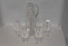 A set of four clear cut crystal goblets or wine glasses by Waterford with similar water jug or