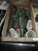 A selection of advertising bottles and advertising cream ware pots