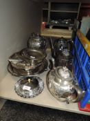 A mixture of plated ware including coin purse,flatware, tea pots and more.
