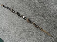 A tribal art style walking cane having carved head to handle.
