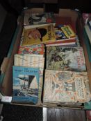 A box of mixed interest books including novels.