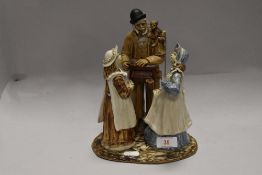 A studio pottery figure base in a folk art style of a monkey grinder or organ
