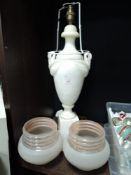 A carved alabaster or similar lamp base having twin sawn handles and two 50's shades