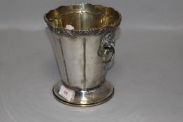 A silver plated ice bucket having mythical beast handles