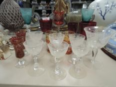 An assortment of etched and coloured glass, two blue examples having multi air twists to stems.
