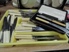 A mixed lot of bone handled cutlery, nut crackers and more.