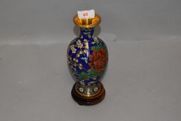 A cloisonne vase having beep blue ground with cherry blossom design