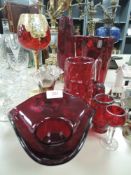 An assortment of red art glass including Whitefriars vase.