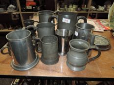 A selection of antique and later pewter tankards and mugs including large double pint