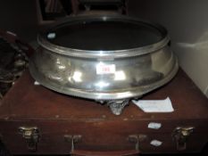 A vintage wedding cake stand having mirrored face and etched design to front.