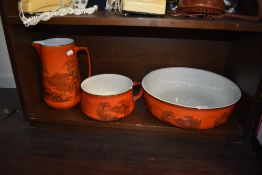 A large wash jug and bowl set in a red glaze transfer print by Adams and son