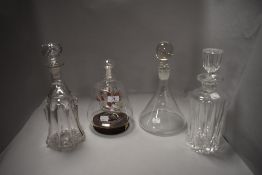 A selection of clear cut crystal glass decanters including one model ship in bottle