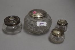 Four pressed glass dressing table pots with HM silver lids