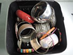 A selection of costume jewellery including bangles and travel case