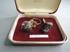 A set of white metal and polished stone cufflinks and a white metal ring stamped silver having a