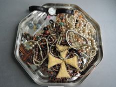 A small selection of costume jewellery including wrist watches, gold plated chains, strings of beads