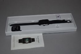 An ID205L smart watch with box and user manual.