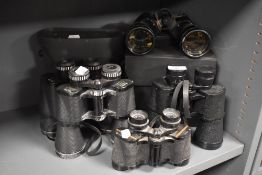 A selection of binoculars and cases including Prinz and Aerolite.