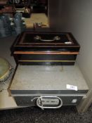 A deed box and a vintage petty cash tin or similar.