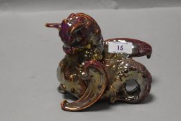 A Leeds Fireclay Company purple lustre baby dragon figure, impressed marks to base, number 2168, AF