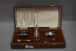 A cased three piece silver plated cruet set