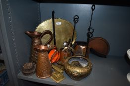 A selection of metal wares including enamel ladle, copper jugs, brass anvil, and copper cider