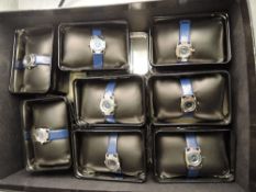Eight boxed ladies Cosmopolitan wrist watches, all same design with blue straps