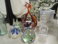 A selection of art glass wares including paper weights and Waterford clock