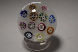 A glass art Perthshire paper weight having ribbon swirl centre with makers canes including panda