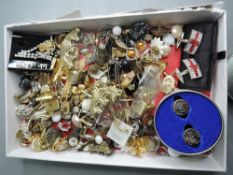 A box containing a selection of costume jewellery earrings and cufflinks etc