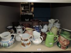 A selection of water jugs and similar tea pots and creamers including Beswick character jug