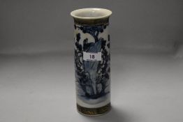 A Chinese pottery cylindrical vase, decorated with flora and fauna between incised bands,