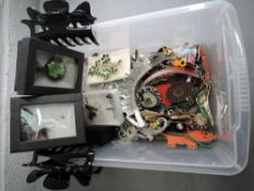 A selection of costume brooches and glass pendants etc