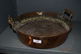 A Victorian heavy gauge copper pan, with applied brass handles
