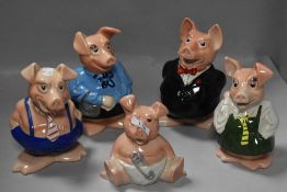 A family of five Wade Nat West Piggy banks, each with stopper to base.