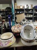 A collection of ceramics and glass including fruit bowls,apothecary style bottle, vases and more.