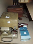 A vintage photographic slide projector by Aldis and similar portable examples