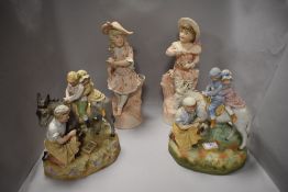 A group of four figurines including two variants of a farrier shoeing a donkey with two children