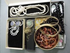 A selection of costume jewellery including gold plated chains, diamante, two strings of mourning