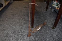 A vintage child's scooter (corroded throughout)