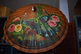 A mid century oriental parasol having peacock,flora and bamboo painted details.