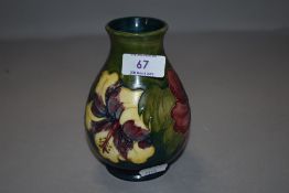 A vintage Moorcroft vase having green hue ground with anemone design
