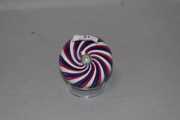 A Perthshire glass paperweight, with central milliefiori canes within a spiralled surround, signed