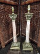 A pair of large pink marble and ormolu decorated Roman style column lamp bases both having damage