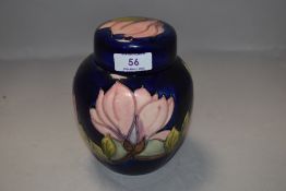 A vintage Moorcroft ginger jar having deep blue ground in the Magnolia design