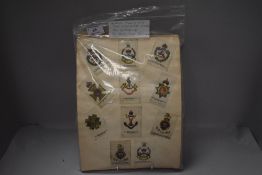 A collection of Silk Cigarette Cards on 36 pages, all stuck down, approx 300, Military Badges, World
