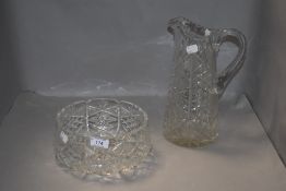 A clear cut crystal glass bowl and similar water jug
