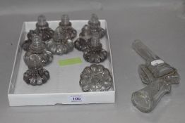 Ten glass draw or door handles and a novelty glass gun shaped bottle.