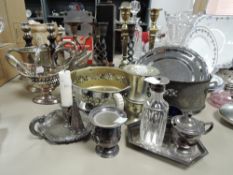 A selection of metal and silver plated wares including candle stick pairs and serving dishes
