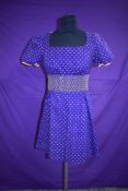 A collectable 1960s cotton day dress in purple with yellow polka dot pattern, Designed by Diana